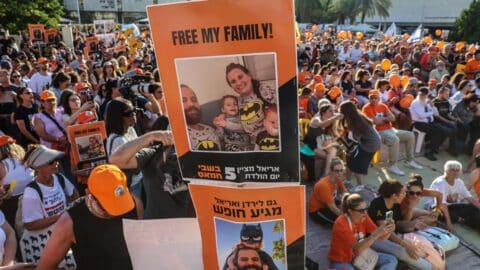 Participants lift placards and pictures during a gathering in Tel Aviv on August 5, 2024 to mark the fifth birthday of Ariel Bibas, held hostage in Gaza, and to call for the liberation of him and his family. Ariel, his baby brother Kfir, who would now be one year old, were kidnapped along with their parents Yarden and Shiri from their homes in Nir Oz kibbutz community near Gaza on October 7 when Hamas terrorists attacked southern Israel.