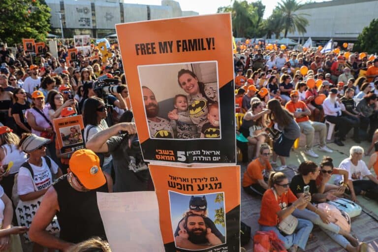 Participants lift placards and pictures during a gathering in Tel Aviv on August 5, 2024 to mark the fifth birthday of Ariel Bibas, held hostage in Gaza, and to call for the liberation of him and his family. Ariel, his baby brother Kfir, who would now be one year old, were kidnapped along with their parents Yarden and Shiri from their homes in Nir Oz kibbutz community near Gaza on October 7 when Hamas terrorists attacked southern Israel.