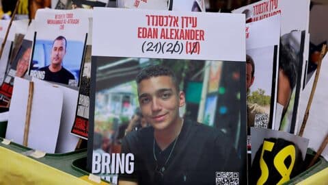 A sign showing the face of Israeli-US hostage Edan Alexander (C), who has been held by Hamas in Gaza since October 2023, is pictured among portraits of other Israelis held captive in Gaza at Hostages Square in Tel Aviv on May 12, 2025.