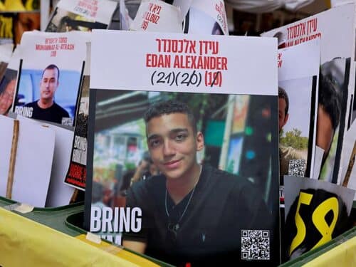 A sign showing the face of Israeli-US hostage Edan Alexander (C), who has been held by Hamas in Gaza since October 2023, is pictured among portraits of other Israelis held captive in Gaza at Hostages Square in Tel Aviv on May 12, 2025.