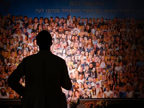 A person views a collage as relatives and supporters of Israeli hostages, taken by Palestinian militants during the October 7 Hamas attack, attend the Nova memorial near Kibbutz Reim in southern Israel, the site of the Nova music festival attacked by militants, during the first anniversary of the attacks on October 7, 2024. (Photo by John Wessels / AFP) (Photo by JOHN WESSELS/AFP via Getty Images)
