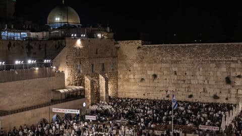 Ultra-Orthodox Jewish men gather for prayers and a reading from the biblical Book of Lamentations at the Western Wall in Jerusalem's Old City on August 2, 2025, during the annual Tisha B'Av (Ninth of Av) fasting and memorial day, commemorating the destruction of ancient Jewish temples some 2000 years ago. (Photo by Menahem Kahana / AFP) (Photo by MENAHEM KAHANA/AFP via Getty Images)