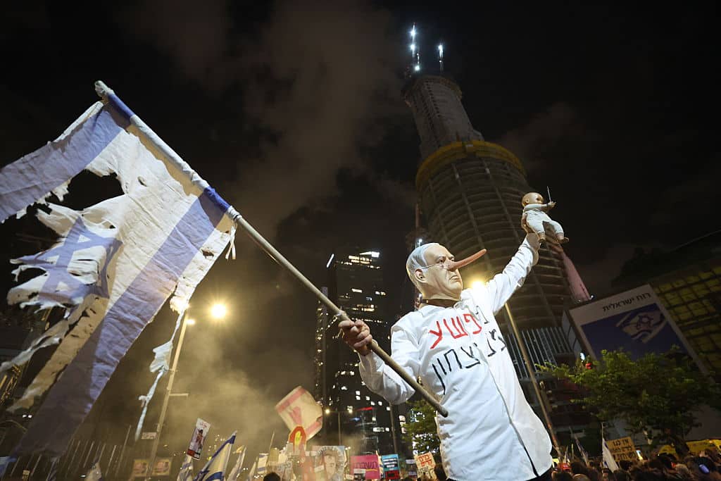 TEL AVIV, ISRAEL - AUGUST 16: People stage a protest to demand an end to the war in Gaza and the release of Israeli hostages as they gather in front of the Ministry of Defense in Tel Aviv, Israel on August 16, 2025. (Photo by Saeed Qaq/Anadolu via Getty Images)