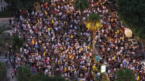 TEL AVIV, ISRAEL - AUGUST 17: People gather to stage a protest as part of a one-day general strike, demanding that the government abandon its decision to fully occupy Gaza City and sign a prisoner exchange agreement in Tel Aviv, Israel on August 17, 2025. (Photo by Yair Palti/Anadolu via Getty Images)