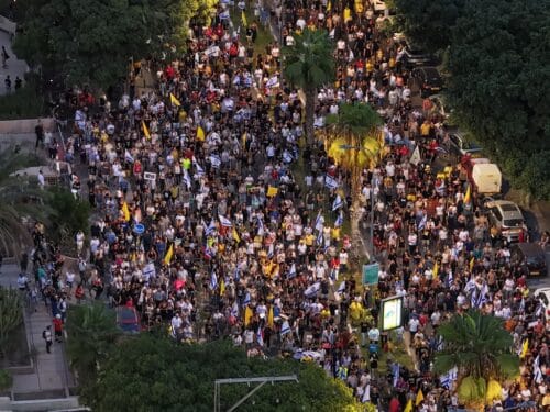 TEL AVIV, ISRAEL - AUGUST 17: People gather to stage a protest as part of a one-day general strike, demanding that the government abandon its decision to fully occupy Gaza City and sign a prisoner exchange agreement in Tel Aviv, Israel on August 17, 2025. (Photo by Yair Palti/Anadolu via Getty Images)