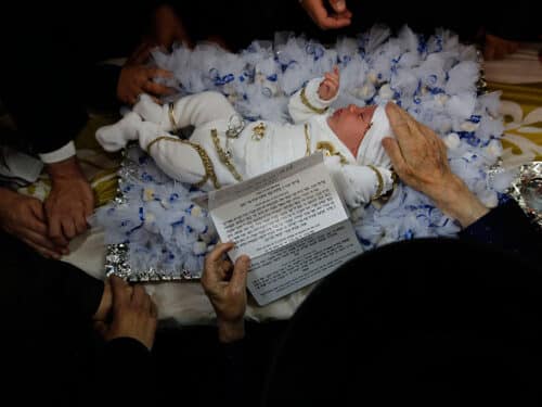 REHOVOT, Sept. 7, 2016 -- An ultra orthodox Jewish Rabbi of the Kretchnief Hasidic sect blesses a thirty-day-old infant during the "Pidyon Haben" ceremony at a synagogue in Rehovot, 30 km south of Tel Aviv, Isreal, Sept. 6, 2016. The Pidyon Haben, or redemption of the first-born son, is a mitzvah in Judaism whereby a Jewish firstborn son is redeemed by use of silver coins from his birth-state of sanctity. (Xinhua/Gil Cohen Magen via Getty Images)