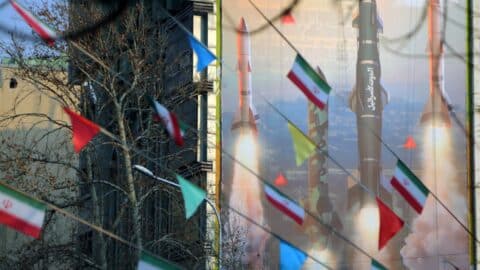 A view of a banner hung on a building reading in Persian and Hebrew 'We are stronger and more motivated than ever. Are you ready for 2 million displaced people?' with pictures of Iranian missiles as tensions between Iran and Israel continue to escalate in Palestine Square of the capital Tehran, Iran.