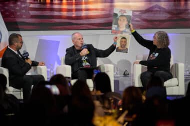 Freed hostages Keith and Aviva Siegel held up pics of hostages they hope will be freed in their interview at the JPost conference. (Perry Bindelglass)