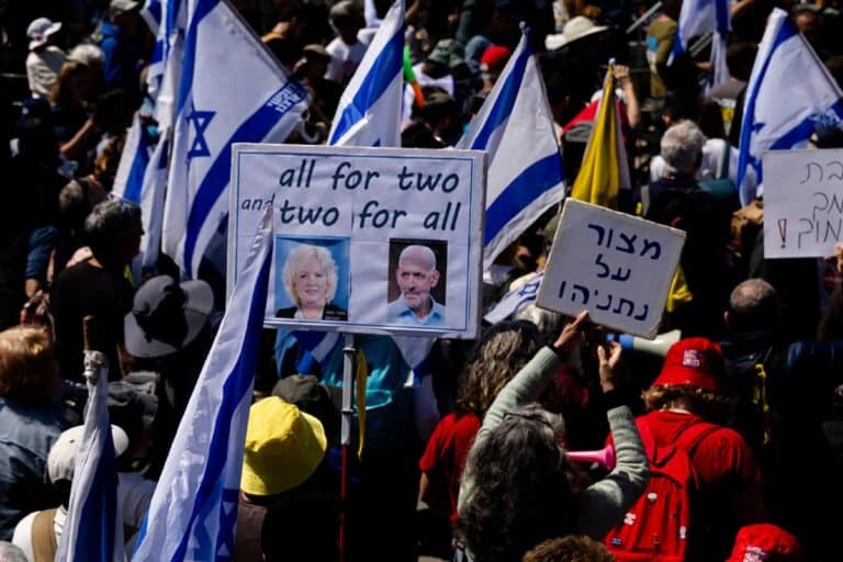 Protesters hold signs with photos of attorney general Gali Baharav Miara and Israel's Shin Bet Director Ronen Bar during a protest against the Israeli government outside the Prime Minister's office on March 23, 2025 in Jerusalem.