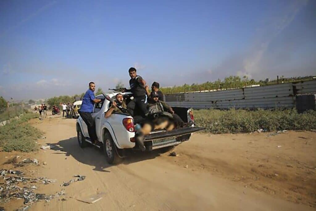 Hamas terrorists drive to the Gaza Strip with the body of Shani Louk, on October 7, 2023.