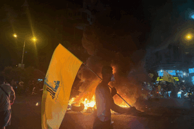 Supporters of Lebanon's Hezbollah terrorist group block the streets with burning tires as they rally in cars and motorbikes to protest the government's endorsement of a plan to disarm it, in Beirut's southern suburbs early on August 8, 2025
