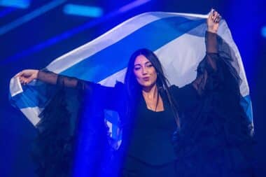 Yuval Raphael from Israel comes on stage with the national flag during a rehearsal for the final show of the 69th Eurovision Song Contest in the Arena St. Jakobshalle.