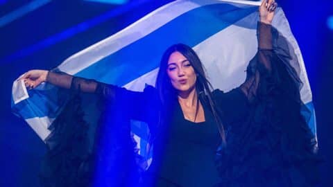 Yuval Raphael from Israel comes on stage with the national flag during a rehearsal for the final show of the 69th Eurovision Song Contest in the Arena St. Jakobshalle.