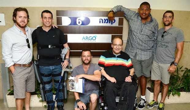Buckley, Giovinazzo, Miller and Togo getting an up-close look at the ARGO ReWalk with test pilot Radi Kaiuf (wearing the exoskeleton) and founder Dr. Amit Goffer. Photo by Michael Kovac/WireImage