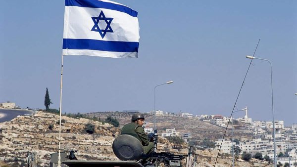 An Israeli flag is raised over a tank in Jerusalem. (Photo by David Butow/Corbis via Getty Images)