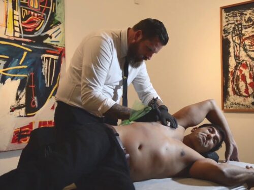 Artist Luke Wessman at the Israel Museum, Jerusalem tattoos an IDF soldier injured in combat over his bullet wounds (courtesy of Craig Dershowitz).